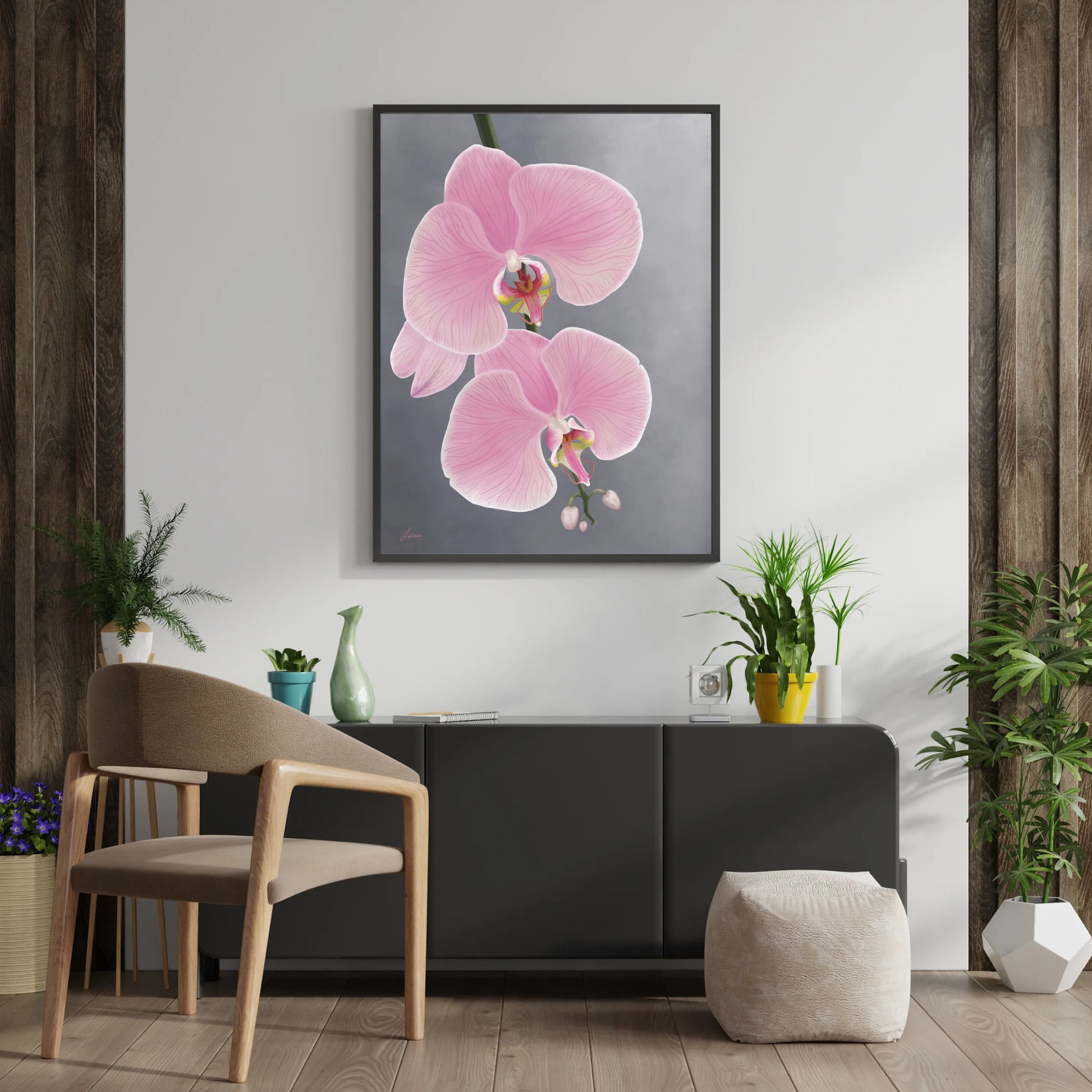 A modern living room features a wooden chair with a beige cushion, a gray pouf, houseplants, and a black console table. Above the table, a framed pink orchid painting on gallery-wrapped canvas hangs on the wall.