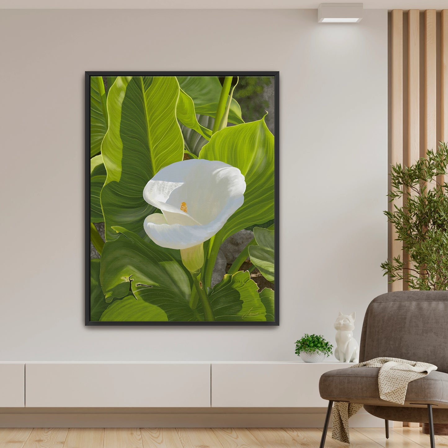 Peaceful modern living room featuring a sun-kissed white calla lily canvas art by Lisane Art, contrasted beautifully by bright green intricate foliage - enclosed in a sleek black floating frame for contemporary contrast.