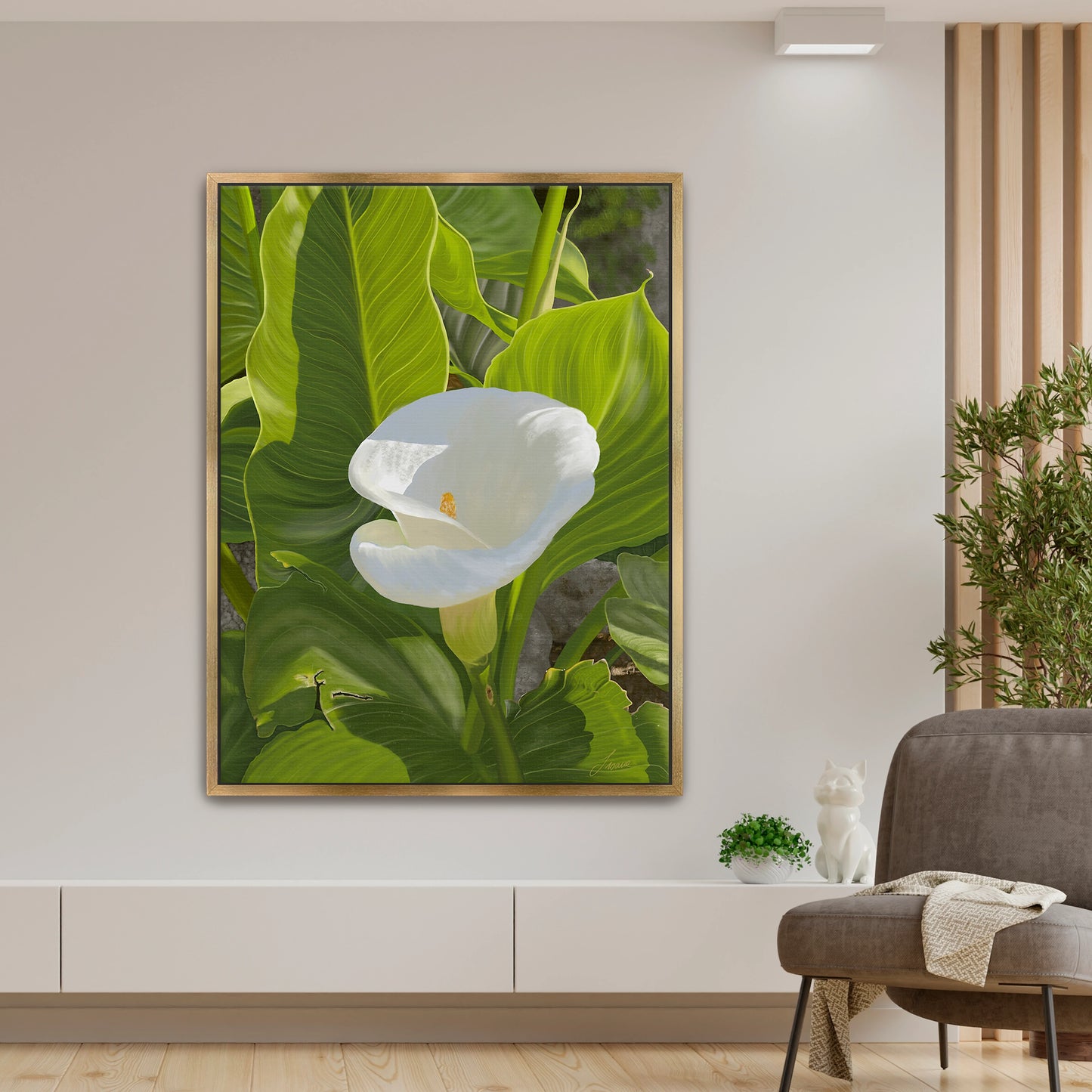 Peaceful modern living room featuring a sun-kissed white calla lily canvas art by Lisane Art, contrasted beautifully by bright green intricate foliage - elegantly framed in a luxurious gold floating frame.