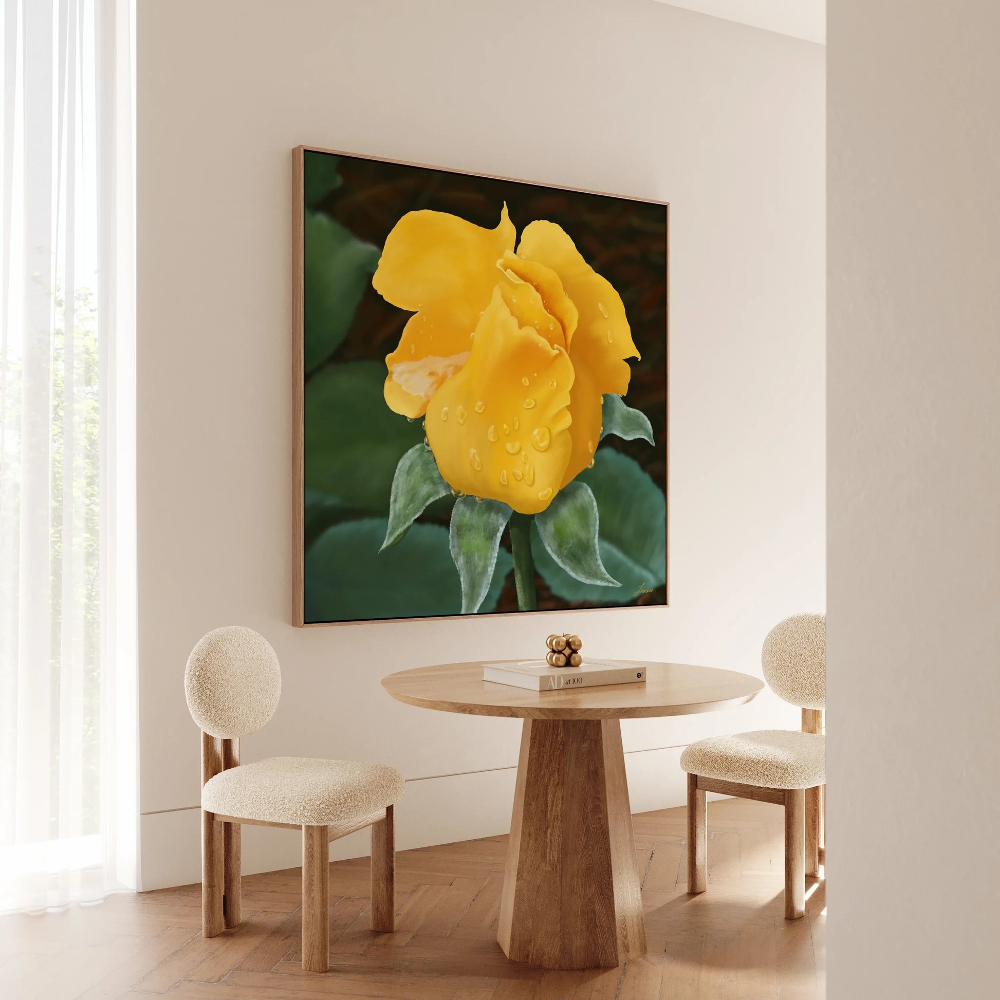 A minimal dining nook with two textured cream chairs and a round wooden table. On the wall, a yellow rose canvas printed on archival-grade canvas adds a vibrant focal point to the light, modern space as natural light filters through sheer curtains.