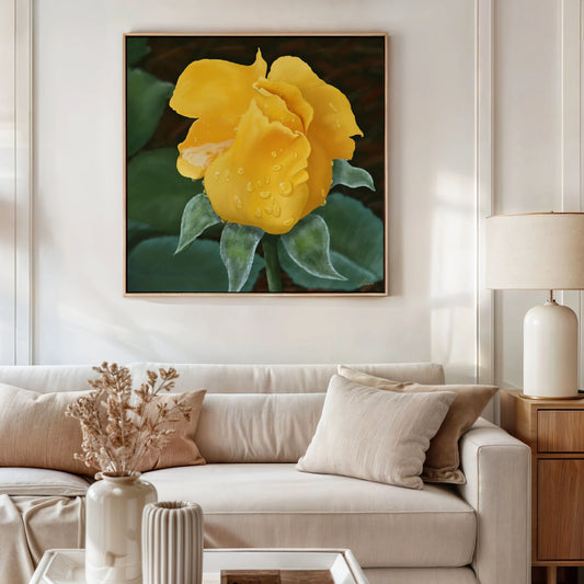 A modern living room with a cream sofa, beige cushions, a wooden side table with a lamp, and a vase of dried flowers. Above the sofa hangs a yellow rose canvas in floating frame options, printed with vibrant eco-solvent ink.