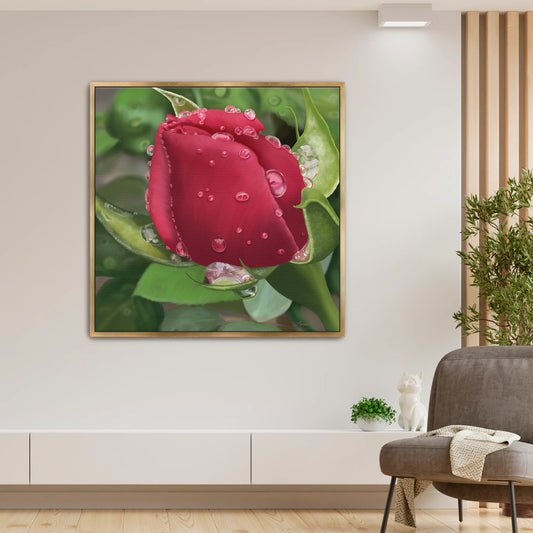 Modern living room featuring a vivid red rose canvas art by Lisane Art, adorned with glistening raindrops against a softly blurred leafy green background - elegantly framed in a luxurious gold floating frame.  