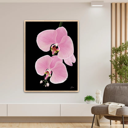 A modern living room with a large framed painting of orchid flowers, titled Midnight Bloom, on a black background. The artwork creates statement walls above a low white cabinet, accented by cozy touches like a gray chair and green plant.