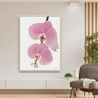 Fresh, modern living space showcasing a vibrant pink orchid canvas art by Lisane Art, with blossoms flowing leftward against a clean white background - framed in natural maple wood for a warm, refined look. 
